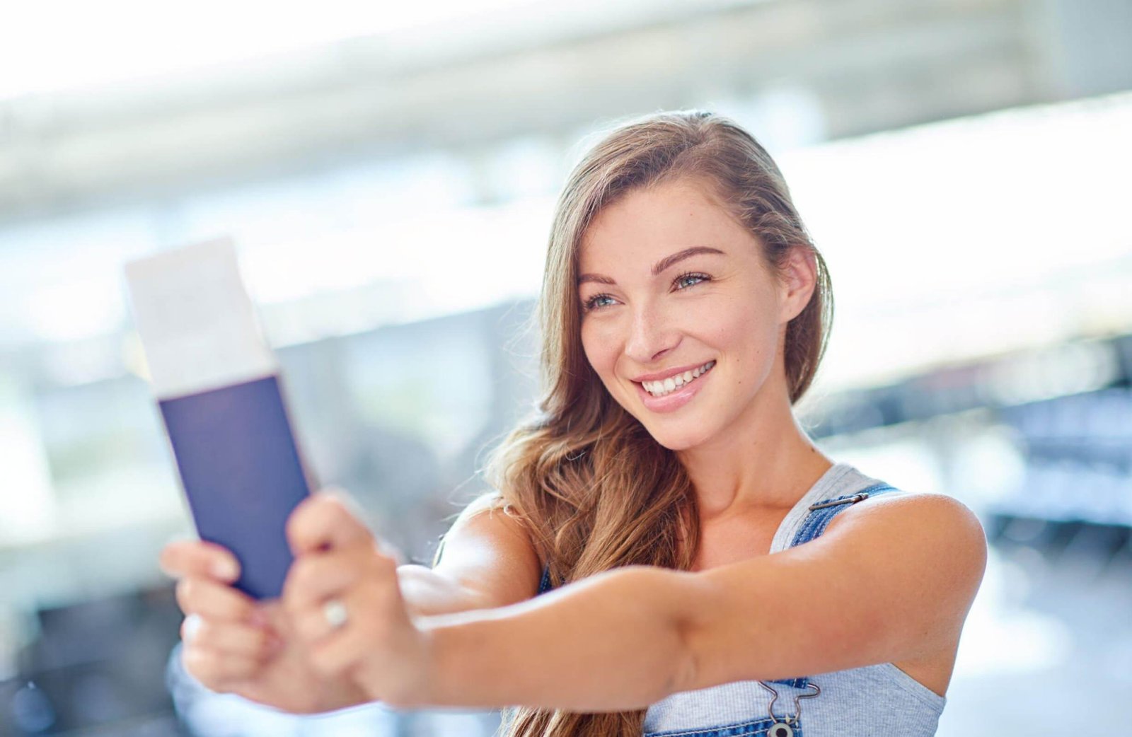 Student with passport and suitcase at airport